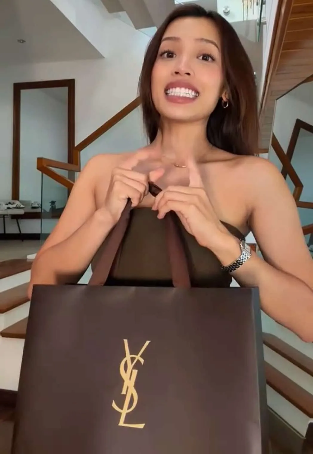 Lilthu holding a YSL shopping bag